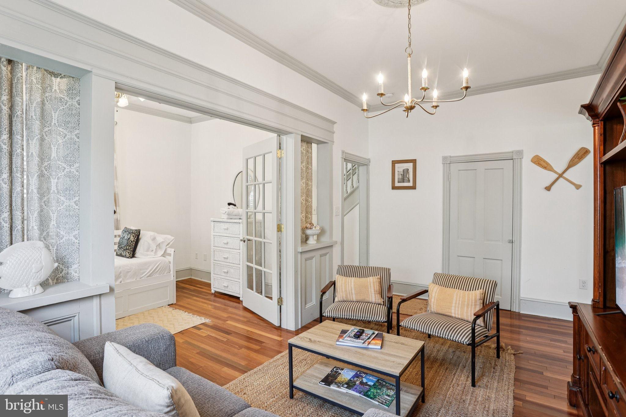 416 Broadway Cape May, NJ 08204 - Photo 28 of 49 a living room with furniture and a chandelier