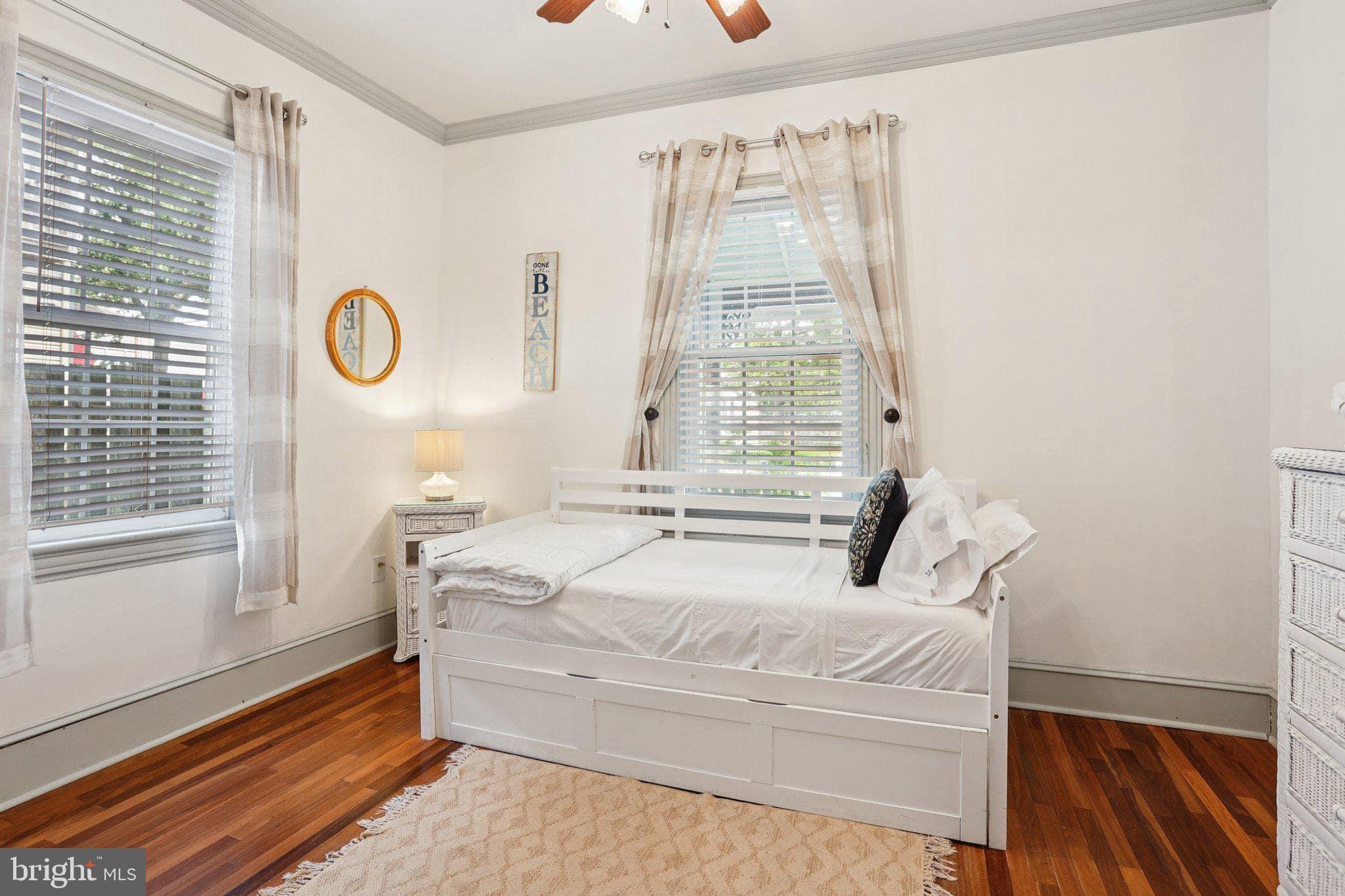 416 Broadway Cape May, NJ 08204 - Photo 29 of 49 a bedroom with a bed and a window