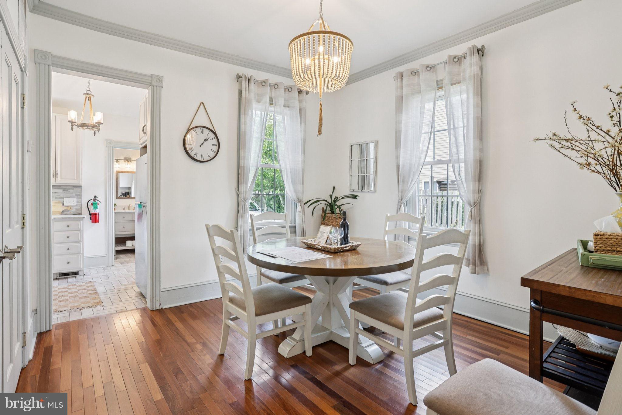 416 Broadway Cape May, NJ 08204 - Photo 33 of 49 a view of a dining room with furniture wooden floor and a chandelier