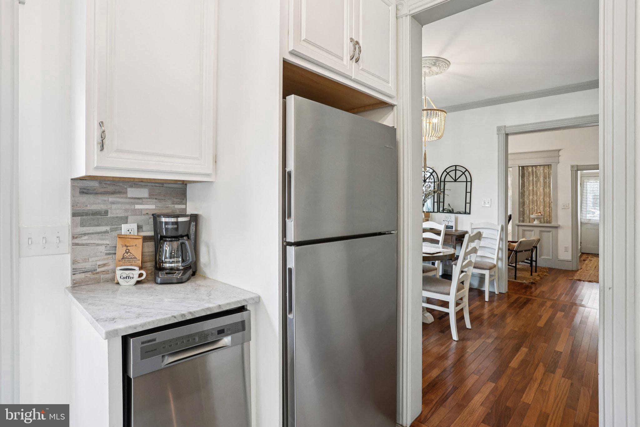416 Broadway Cape May, NJ 08204 - Photo 34 of 49 a kitchen with stainless steel appliances a refrigerator and wooden floor