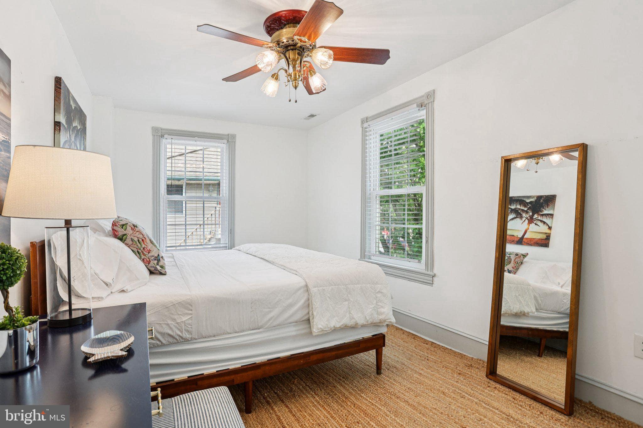 416 Broadway Cape May, NJ 08204 - Photo 41 of 49 a bedroom with a bed and a window