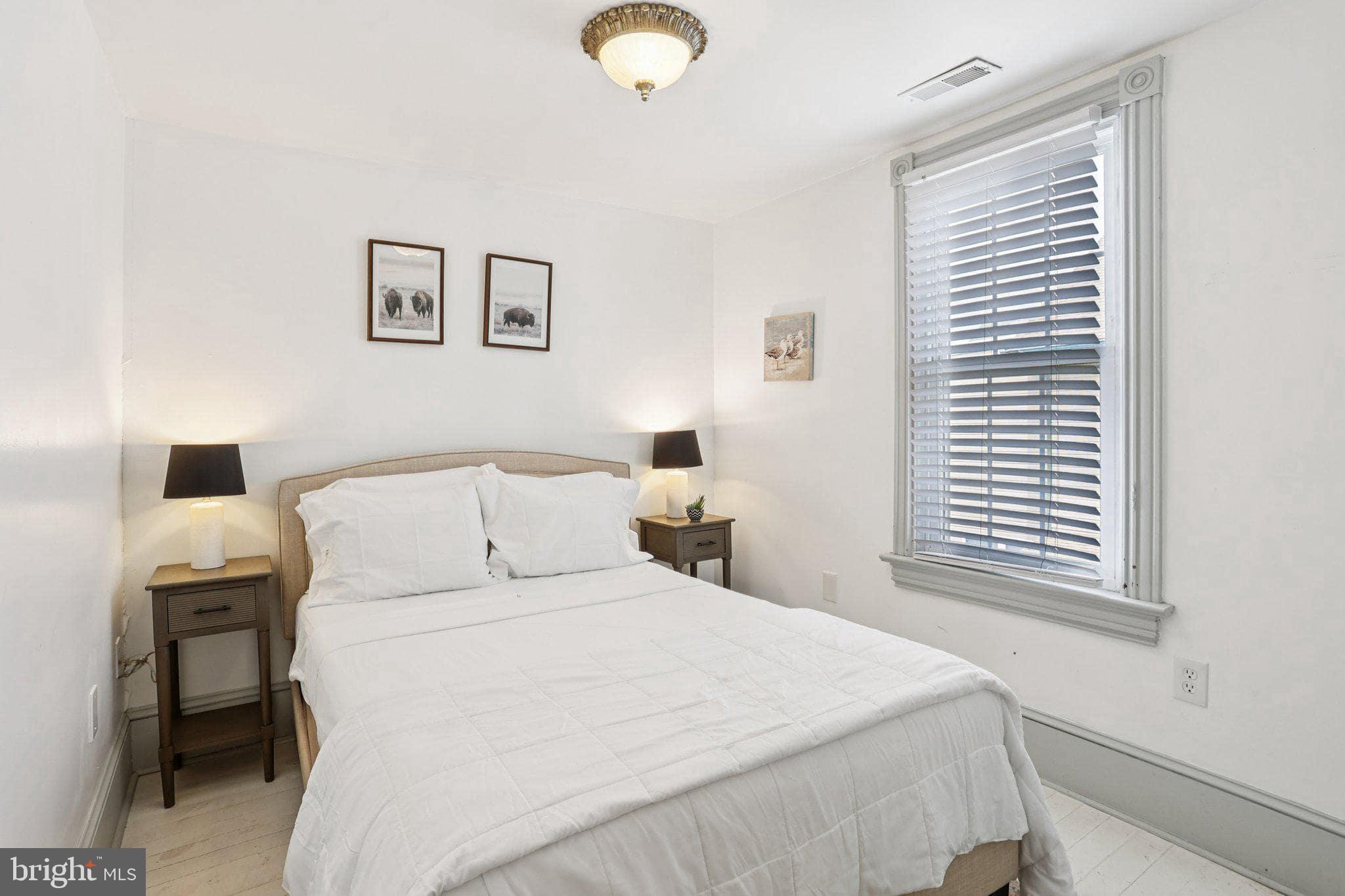 416 Broadway Cape May, NJ 08204 - Photo 45 of 49 a bedroom with a bed and a window