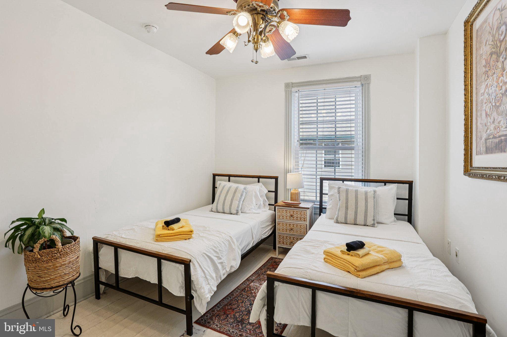 416 Broadway Cape May, NJ 08204 - Photo 49 of 49 a bedroom with a bed and a table in it