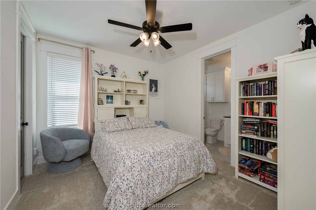 3317 Stone Leigh Lane Bryan, TX 77808 - Photo 18 of 30 a bedroom with a bed furniture and a book shelf