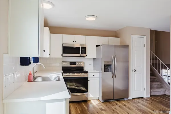 a kitchen with stainless steel appliances a refrigerator stove and sink