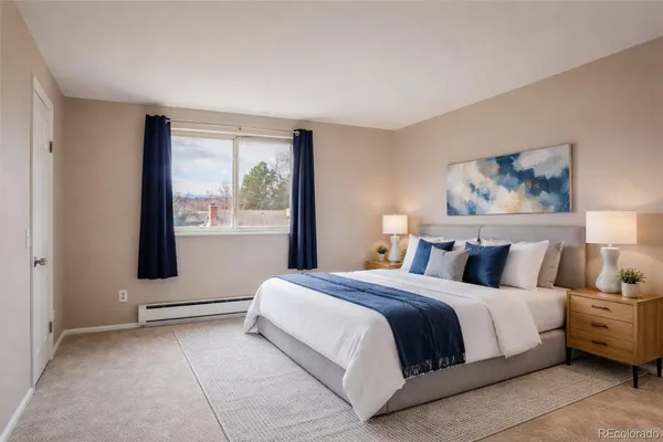 a bedroom with a large bed and a window