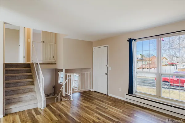 a view of a livingroom with wooden floor and a window