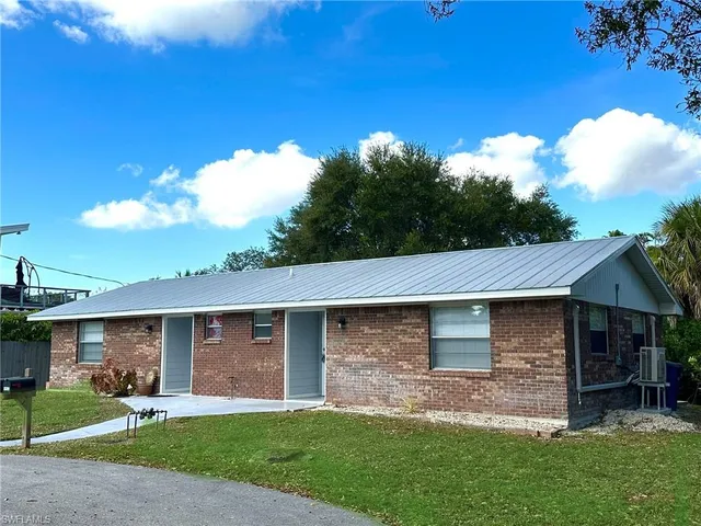 a aerial view of a house with a yard and garage