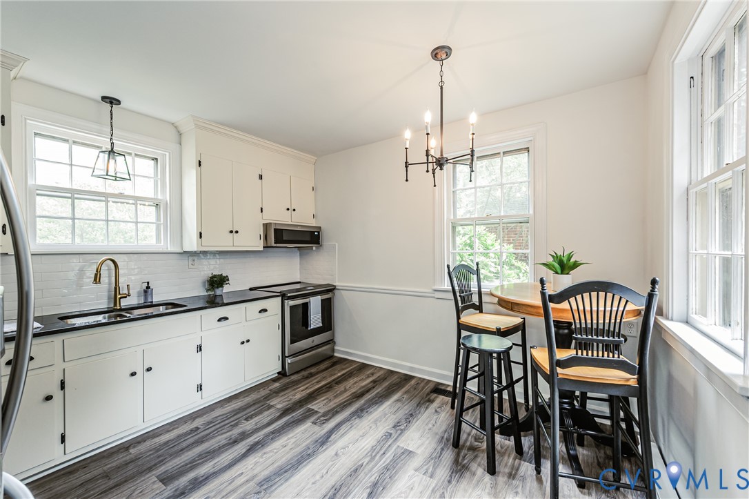 401 Caroline Street Ashland, VA 23005 - Photo 15 of 63 a kitchen with sink table and chairs