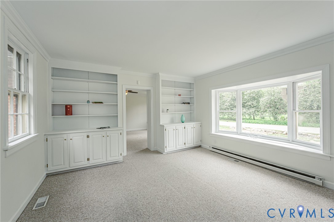 401 Caroline Street Ashland, VA 23005 - Photo 25 of 63 an empty room with a window and cabinet