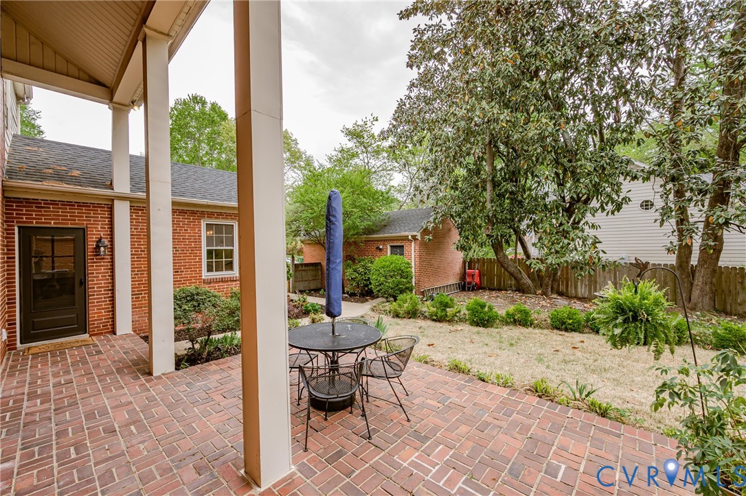 401 Caroline Street Ashland, VA 23005 - Photo 50 of 63 a view of a patio with table and chairs potted plants and large tree