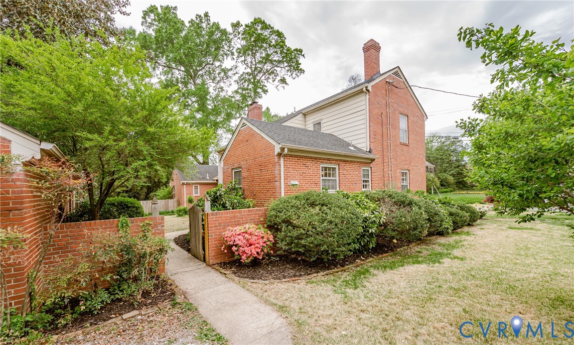 401 Caroline Street Ashland, VA 23005 - Photo 55 of 63 The property features a brick exterior with a chim