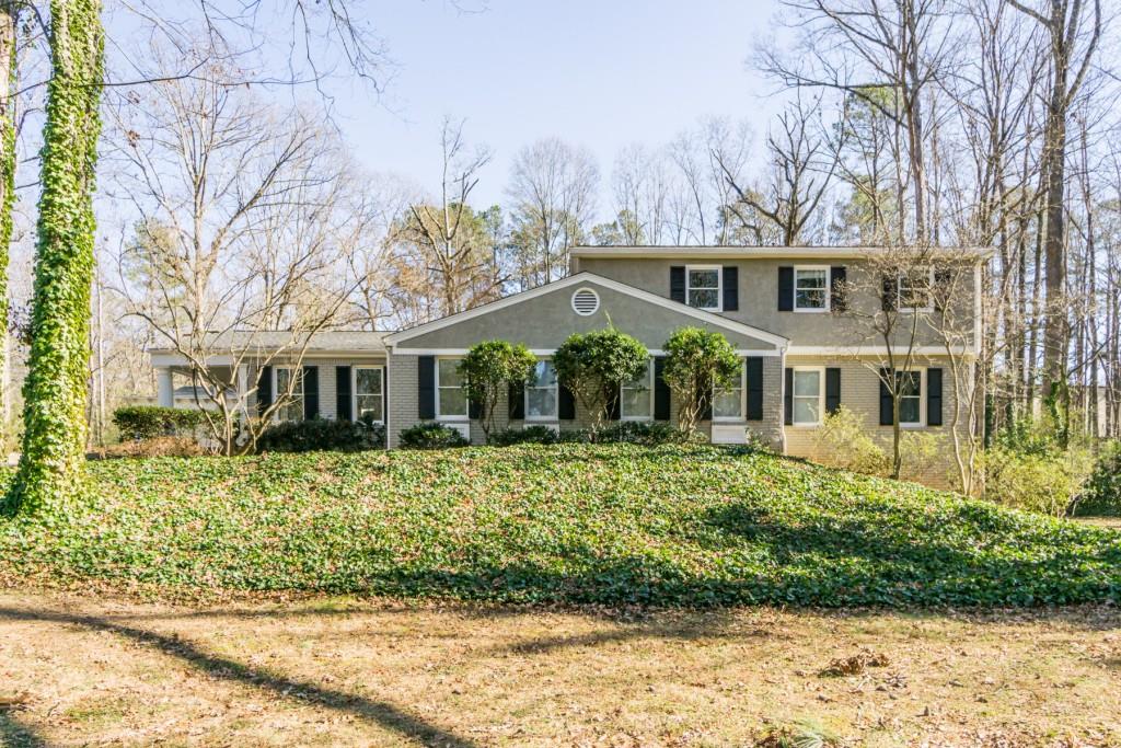 7185 Brandon Mill Road Northwest Atlanta, GA 30328 - Photo 1 of 1 a front view of a house with a yard