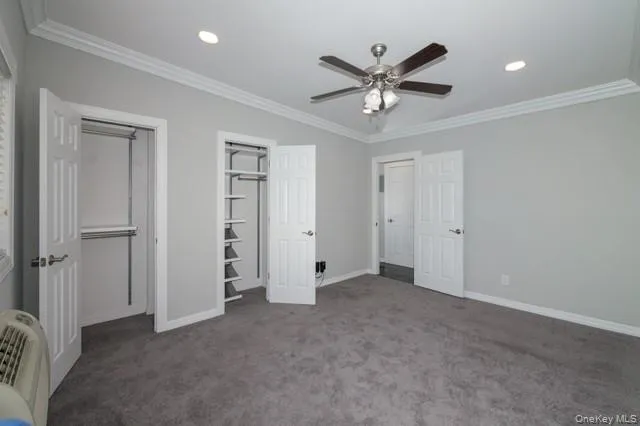 a view of an empty room with a ceiling fan