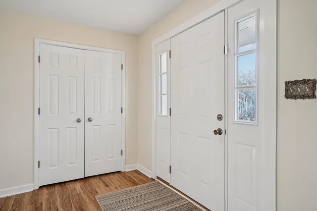 a kitchen with stainless steel appliances granite countertop a sink a stove counter space and living room