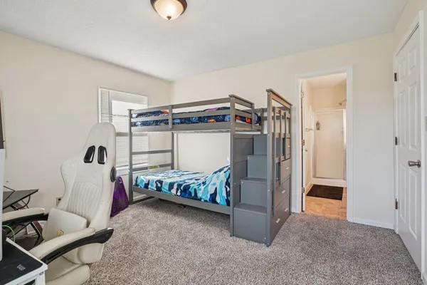 a bedroom with a bed and a desk