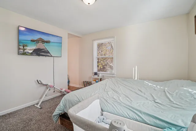 a utility room with furniture and a wooden floor