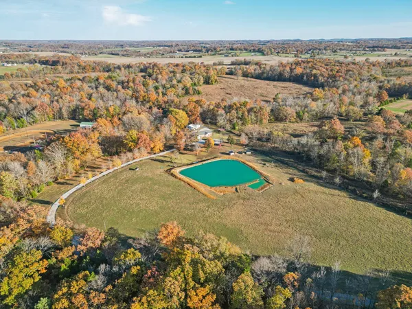 a view of a house with a yard covered in snow