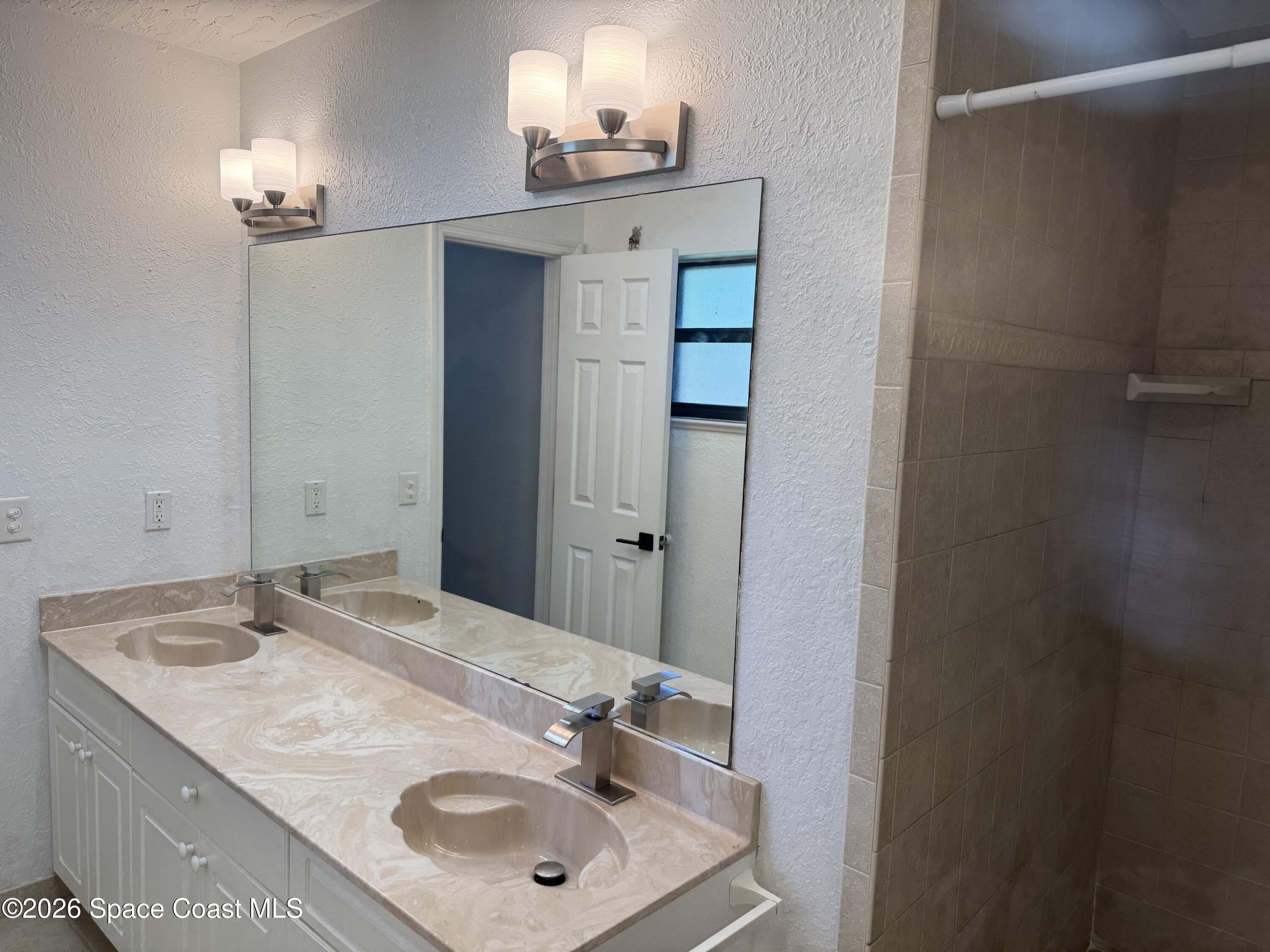 2135 South River Road Melbourne Beach, FL 32951 - Photo 11 of 14 a bathroom with a sink and a mirror