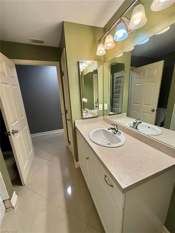 3908 Lee Boulevard Lehigh Acres, FL 33971 - Photo 12 of 24 Bathroom featuring tile patterned flooring and vanity