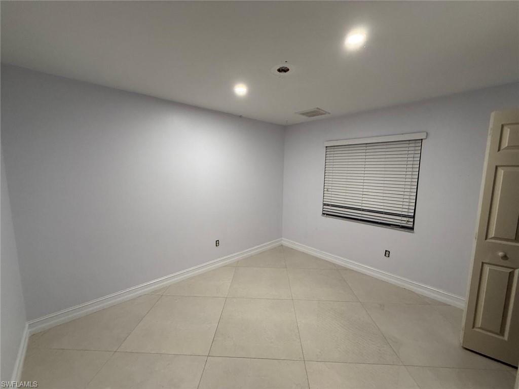 3908 Lee Boulevard Lehigh Acres, FL 33971 - Photo 14 of 24 Unfurnished room featuring light tile patterned floors