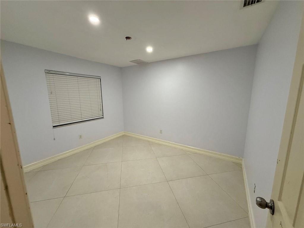 3908 Lee Boulevard Lehigh Acres, FL 33971 - Photo 15 of 24 Unfurnished room with light tile patterned floors