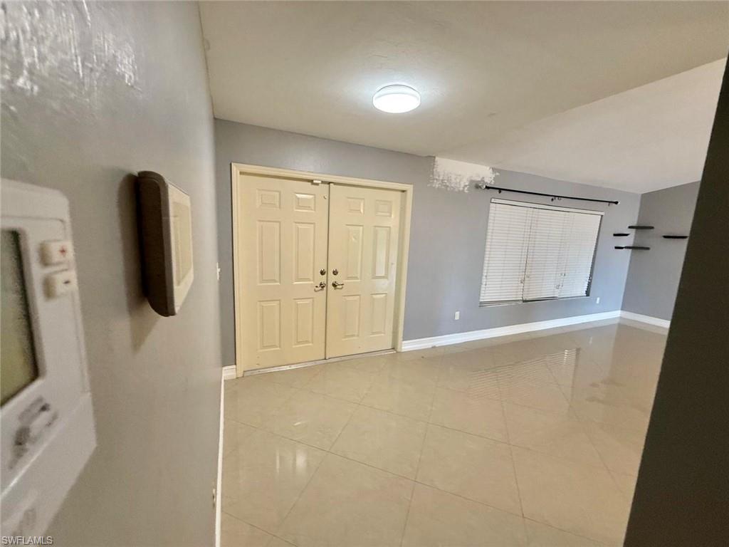 3908 Lee Boulevard Lehigh Acres, FL 33971 - Photo 7 of 24 Entrance foyer featuring light tile patterned floors
