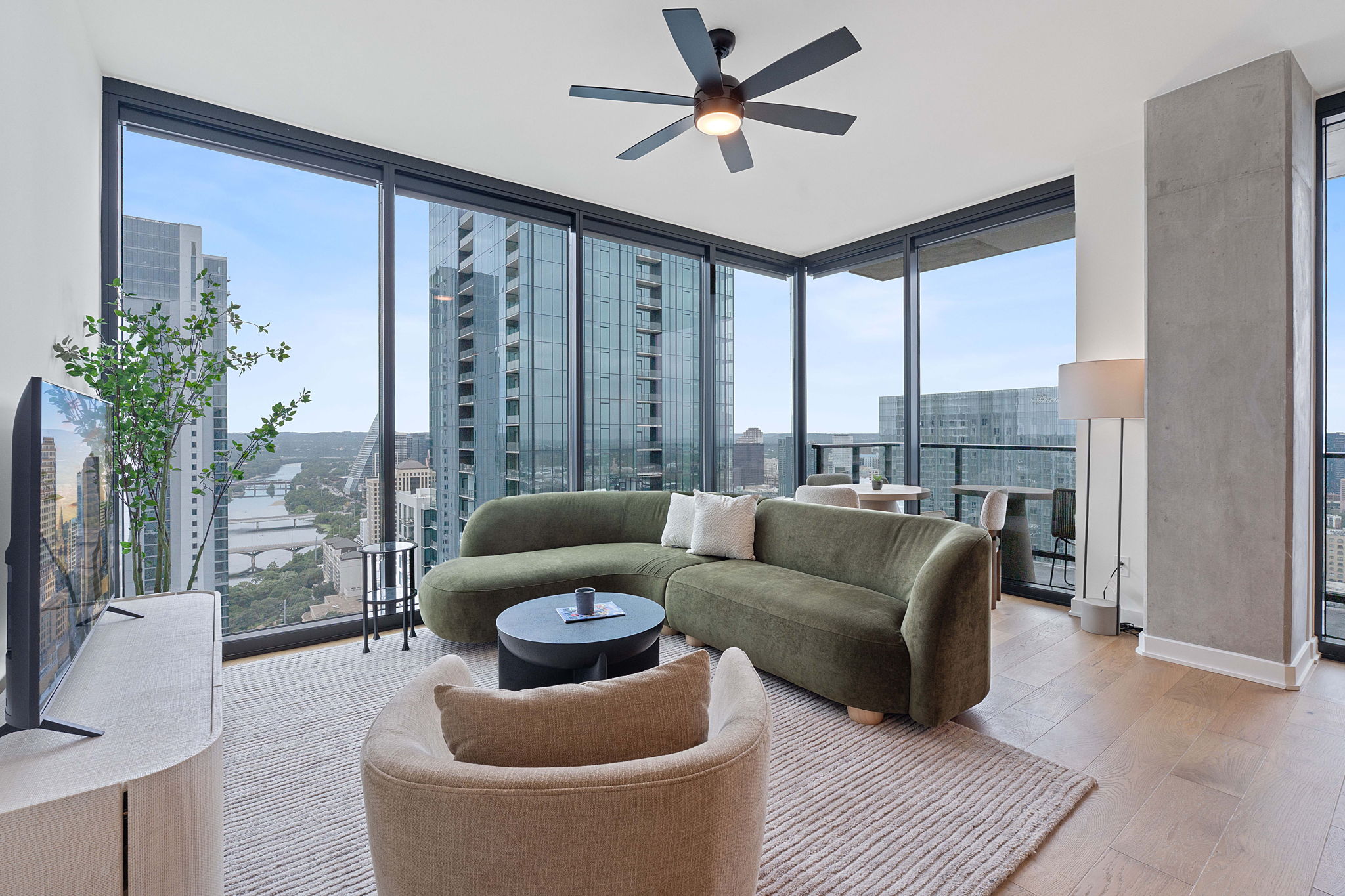Representative Photo. Open Concept living room with 7.5" wide Bella Cera hardwood flooring, recessed lighting, ceiling fan, and a balcony off the living room with a North West view