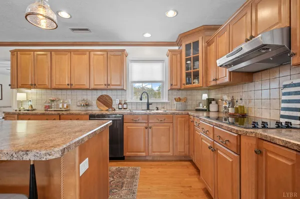 a kitchen with stainless steel appliances granite countertop wooden cabinets a sink and dishwasher