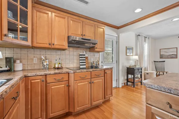 a kitchen with stainless steel appliances granite countertop a refrigerator and a stove top oven