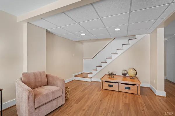 a living room with furniture wooden floor and a flat screen tv