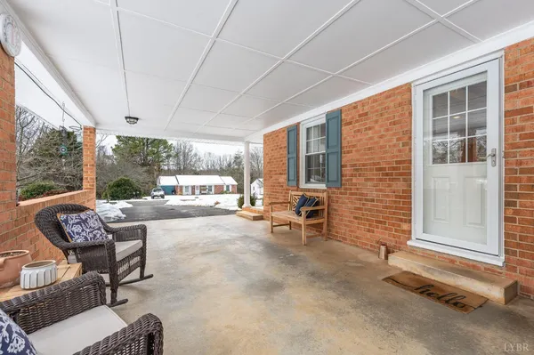 a view of a terrace with chairs and couches