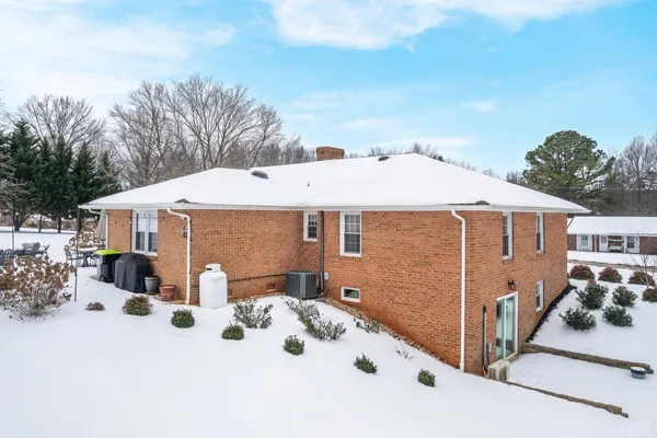 a view of a house with a snow in the yard