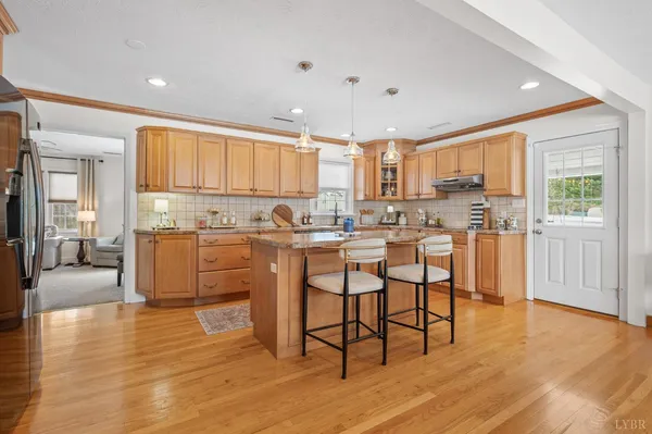 a kitchen with stainless steel appliances granite countertop a sink stove and cabinets