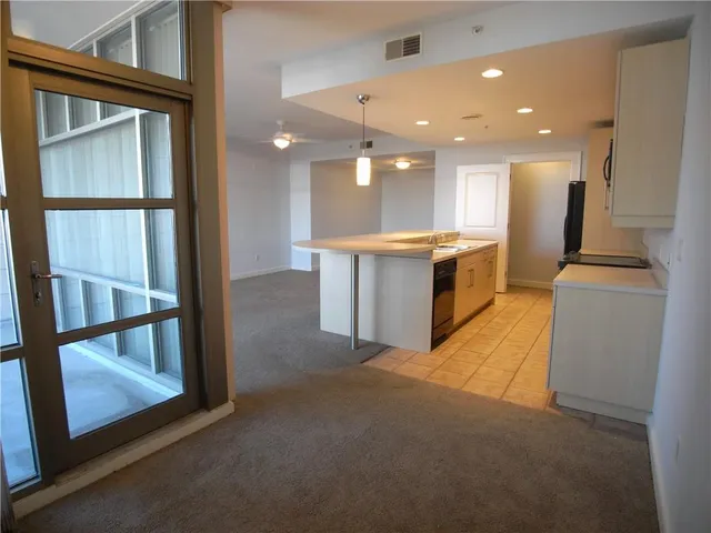 a view of a kitchen with a sink and chandelier