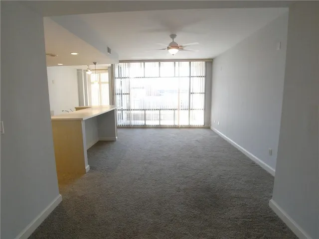 a large kitchen with a sink and a refrigerator