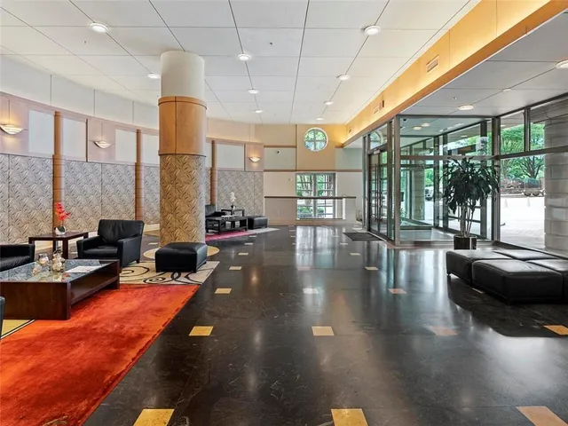 a lobby with furniture and floor to ceiling window