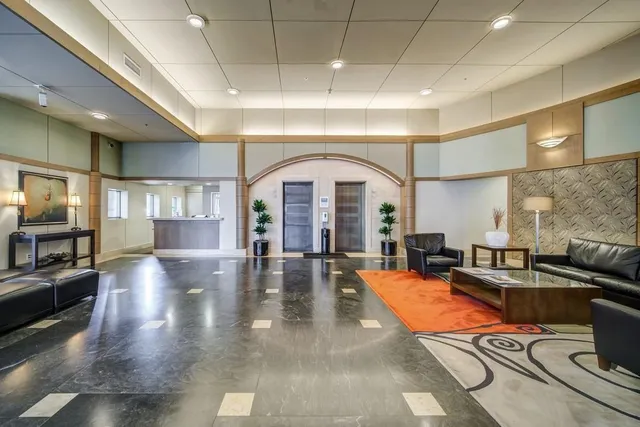 a living room with patio furniture and a fireplace
