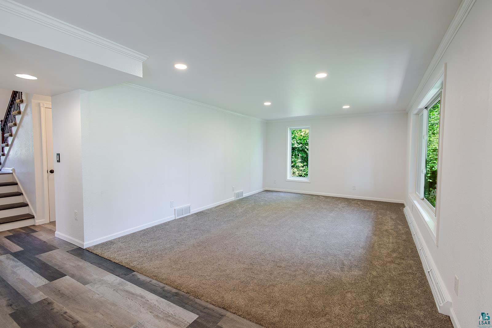 29 Ridge Road Esko, MN 55733 - Photo 10 of 41 Spacious room featuring neutral carpeting, recessed lighting, and multiple windows