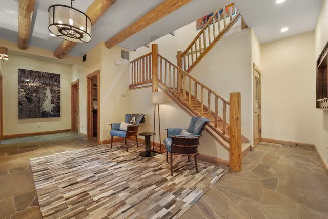 a view of entryway and hall with wooden floor