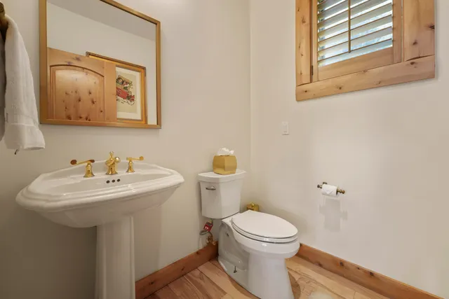 a bathroom with a toilet sink and mirror