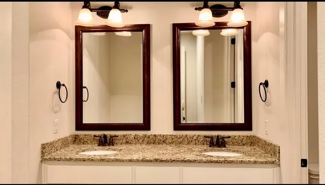 a bathroom with sinks and a granite countertop