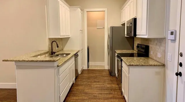 a kitchen with a sink stove and refrigerator