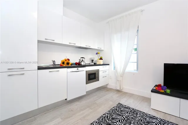 a kitchen with a stove and white cabinets