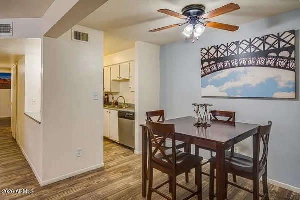 a view of a dining room with furniture and wooden floor