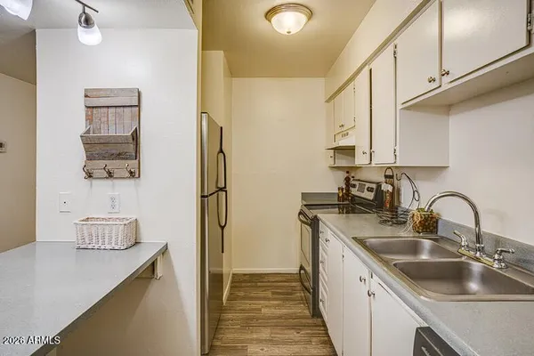 a kitchen with stainless steel appliances a sink stove and refrigerator