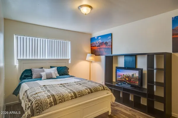 a bedroom with a bed and a flat screen tv