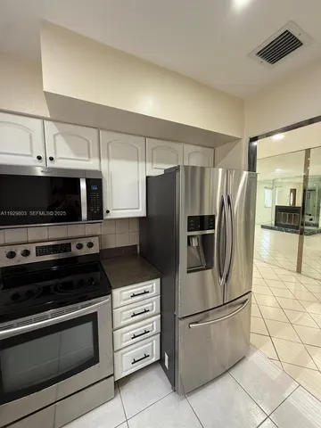a kitchen with granite countertop a sink and a stove