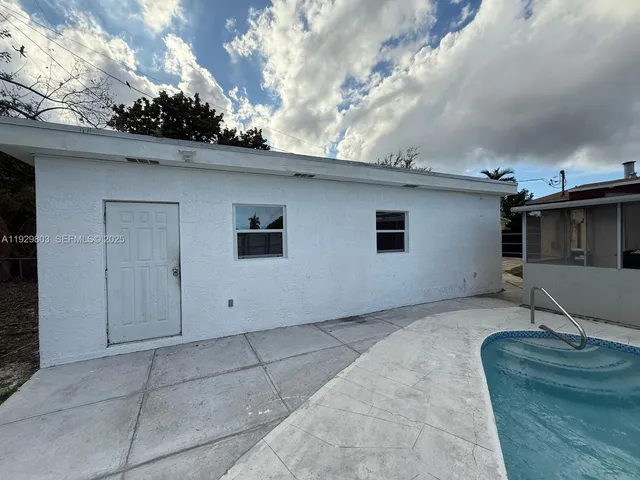 a view of a swimming pool with a yard