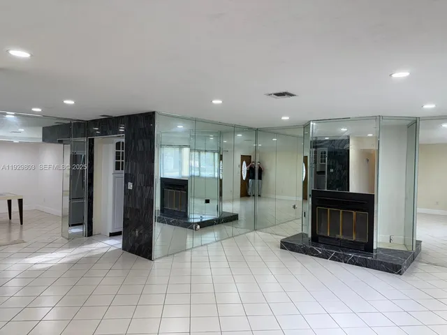 a view of a hallway with a livingroom with furniture